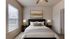 Cozy and elegantly designed bedroom with a modern dark headboard, soft linens, and gentle ambient lighting creating a tranquil atmosphere.