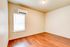 Bright room with elegant hardwood floors and a modern wall-mounted air conditioning unit.