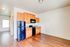 Charming kitchen with warm wooden cabinetry and sleek black appliances in an open-plan layout.