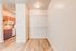 Cozy kitchen area with elegant wooden cabinets, a modern stove, and ample shelving in a bright, inviting setting.