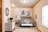 Inviting bedroom with plush bedding, modern decor, and natural light pouring through the window.