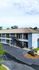 Charming blue two-story apartment building with welcoming balconies and lush greenery, ideal for tranquil living.