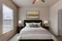 Serene bedroom with a cozy bed, stylish lamps, and a large window offering abundant natural light.