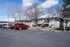 Charming apartment complex with ample parking and mature trees, offering a welcoming residential atmosphere.