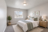 Elegant bedroom suite featuring a cozy bed, stylish bedside tables with warm lighting, and a lush indoor plant for a tranquil ambiance.