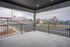 Spacious balcony view showcasing a striking mountain backdrop and bustling street scene, perfect for enjoying scenic outdoor relaxation.