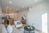 Contemporary open-plan living space with elegant furniture, sleek kitchen, and abundant natural light.