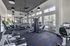 Modern fitness center featuring state-of-the-art cardio and strength training equipment, abundant natural light, and stylish design.