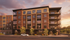 Modern apartment building exterior at sunset showcasing elegant balconies, large windows, and vibrant landscaping. Ideal urban living space.