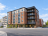 Modern urban apartment complex, Kings Landing, showcasing stylish architecture with spacious balconies and large windows.