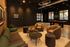 Chic apartment lounge featuring modern furniture, cozy seating, stylish decor, and a pool table under ambient lighting.