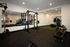 Modern fitness center equipped with advanced gym equipment, mirrored walls, and abundant lighting for an invigorating workout experience.