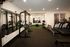 Modern gym facility with state-of-the-art equipment, featuring weight machines and treadmills, perfect for a complete workout experience.
