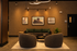 Chic modern lounge with cozy seating, elegant artwork, and soft lighting, creating a warm and inviting atmosphere.