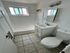 Bright and airy bathroom featuring modern fixtures, a spacious tub, and elegant tile flooring.