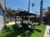 Inviting outdoor lounge with a stylish gazebo and lush greenery, perfect for relaxation and entertaining.