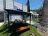 Charming patio space with cozy outdoor seating under a stylish pergola, surrounded by lush greenery and inviting ambiance.