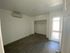 Bright and airy bedroom with sleek modern flooring, spacious closet, and natural light from a large window.