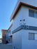 Modern apartment building with a unique architectural design and vibrant accents, showcasing an appealing exterior and secure environment.