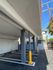 Covered parking area with modern design, featuring sturdy columns and clear parking lines in a well-maintained building.