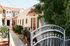 Charming apartment complex with Mediterranean-style architecture, featuring a lush courtyard and welcoming entrance in a vibrant community.
