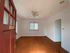 Bright and inviting living space with elegant hardwood floors and large windows, perfect for cozy living.