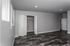 Elegant and spacious room with modern flooring and ample closet space, bathed in natural light from large windows.