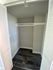 Spacious and modern closet with sleek dark flooring and crisp white doors, perfect for organizing your wardrobe in style.