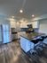 Modern kitchen with sleek stainless steel appliances, elegant dark countertops, and stylish bar seating, offering a contemporary open-concept design.