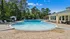 Inviting outdoor pool area with soothing fountains, surrounded by lush greenery and comfortable lounge chairs, perfect for relaxation and leisure.
