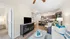 Bright and inviting living space with modern decor, open kitchen layout, and cozy seating area featuring stylish accents and hardwood floors.