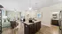 Bright and modern open-concept living area featuring elegant hardwood floors, a stylish kitchen island, and cozy seating. Perfect for entertaining.