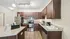 Modern kitchen with sleek granite countertops, stainless steel appliances, and rich wooden cabinetry, ideal for culinary enthusiasts.