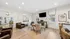 Bright, modern living area with elegant decor featuring comfortable leather seating and a stylish dining table, perfect for entertaining.