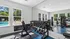 Bright and airy fitness center with modern equipment and views of the inviting outdoor pool area.