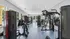 Contemporary fitness center with state-of-the-art exercise equipment and bright natural lighting.