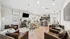 Inviting open-concept living space with plush leather seating, modern decor, and a well-equipped kitchen, ideal for entertaining.