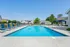 Inviting outdoor swimming pool with sleek loungers and picturesque surroundings, perfect for relaxation.