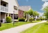 Charming Brookview Apartment Homes with lush green surroundings and inviting pathway under a clear blue sky.