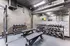 Dynamic gym space with state-of-the-art equipment, including free weights, kettlebells, and sturdy benches for optimal workouts.