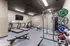 Modern fitness center with treadmills, weights, exercise bike, and sleek equipment for a dynamic workout experience.