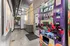 Modern hallway featuring a vibrant vending machine with healthy snack options, industrial ceiling design, and contemporary artwork for an inviting ambiance.