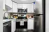Modern kitchen with sleek stainless steel appliances, white cabinetry, and ample counter space for convenient meal preparation.