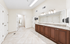 Luxurious bathroom featuring elegant double vanity, granite countertop, and ample lighting for a sophisticated touch.
