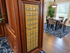 Elegant apartment foyer with classic wooden mailboxes, plush carpet, and a stylish dining area featuring sophisticated decor and abundant natural light.