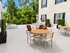 Inviting outdoor patio with comfortable seating, surrounded by lush greenery and stylish lounge chairs, perfect for relaxation and entertaining.