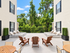Charming outdoor terrace featuring cozy wooden loungers, chic patio seating, and lush greenery, perfect for relaxation and entertaining.