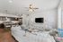 Inviting open-concept living space with cozy seating, modern kitchen, and chic decor, perfect for relaxing and entertaining.