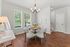 Bright and inviting dining nook with elegant chandelier, modern decor, and large windows offering natural light.