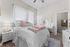 Inviting bedroom with plush bedding, elegant decor, and a cozy ambiance, perfect for relaxation.